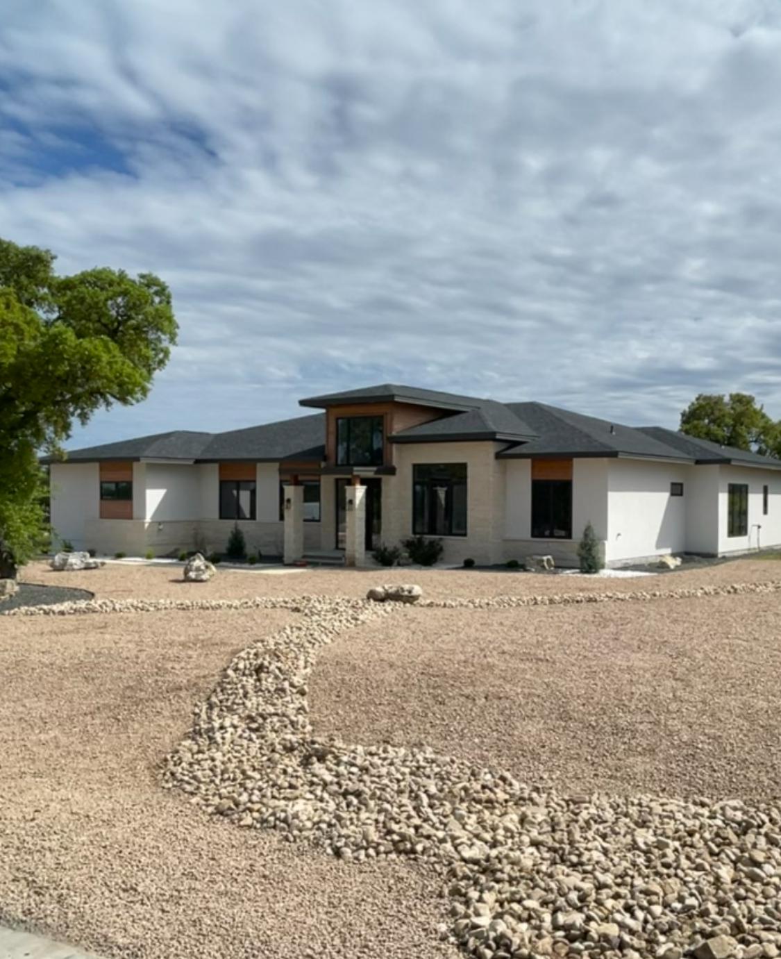 Epic Homes Construction — custom luxury home with stone and stucco facade, Bee Cave Texas